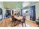 Open-concept dining area with a large window, hardwood floors, designer lighting, and easy access to office at 6995 W 27Th Ave, Wheat Ridge, CO 80033