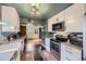 Stylish kitchen showcasing stainless steel appliances, white cabinetry, and adjacent dining area at 6995 W 27Th Ave, Wheat Ridge, CO 80033