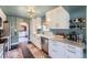 Spacious kitchen boasting white cabinets, stainless appliances, and a charming farmhouse sink at 6995 W 27Th Ave, Wheat Ridge, CO 80033