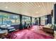 Spacious sun room with wood paneled ceiling, large windows, and finished with plush red carpeting at 6995 W 27Th Ave, Wheat Ridge, CO 80033