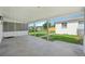 Covered back porch leading to a spacious backyard with green grass and a storage shed at 169 Yates St, Denver, CO 80219