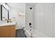 Modern bathroom with tub and shower, white subway tile, and black fixtures at 169 Yates St, Denver, CO 80219