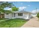 Well-maintained exterior with a detached garage and a long driveway for multiple cars at 169 Yates St, Denver, CO 80219