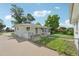 Charming white brick home featuring a well-maintained lawn, concrete driveway, and lovely curb appeal at 169 Yates St, Denver, CO 80219