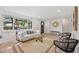 Inviting living room showcasing a large window, comfortable seating, and hardwood floors at 169 Yates St, Denver, CO 80219