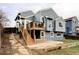 Multi-story home featuring a backyard patio, deck, wood stairs, and blue horizontal siding at 5612 S Himalaya Way, Centennial, CO 80015