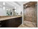 Vanity and tiled shower with glass doors in en-suite bathroom at 512 Cook St, Denver, CO 80206