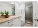 Bright bathroom featuring a vanity, a sink with granite countertop and walk-in shower at 512 Cook St, Denver, CO 80206