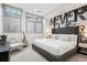 Modern bedroom with a large bed, stylish decor, and a guitar next to the chair at 512 Cook St, Denver, CO 80206