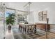 Bright dining room with modern chandelier, large windows, and stylish decor, perfect for entertaining at 512 Cook St, Denver, CO 80206