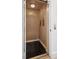 Interior view of residential elevator with wood paneling and black tile floor at 512 Cook St, Denver, CO 80206