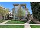 Modern, multi-story home featuring a stone facade, large windows, and a well-manicured lawn at 512 Cook St, Denver, CO 80206