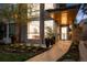 Inviting modern home featuring stone accents, manicured landscaping and a brick walkway to the entrance at 512 Cook St, Denver, CO 80206