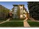 Beautiful modern home with large windows, lush green lawn, and a welcoming brick walkway at 512 Cook St, Denver, CO 80206