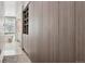 Hallway leading to the bathroom with custom cabinets and wood floors at 512 Cook St, Denver, CO 80206