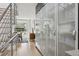 Bright hallway featuring modern staircase and glass cabinetry, with a view into the dining area at 512 Cook St, Denver, CO 80206