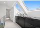 Bright hallway with a skylight above a built in cabinet and views of a bedroom down the hall at 512 Cook St, Denver, CO 80206