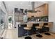 Modern kitchen features an island with bar seating, stainless steel appliances and stylish cabinetry at 512 Cook St, Denver, CO 80206