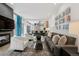 Inviting living room with a fireplace, modern furnishings, and an open layout to the kitchen at 512 Cook St, Denver, CO 80206