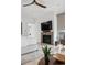 Bright main bedroom with a fireplace, a ceiling fan, and a large window at 512 Cook St, Denver, CO 80206