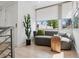 Cozy sitting area featuring a curved sofa, bright window, and stylish modern decor at 512 Cook St, Denver, CO 80206