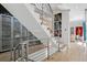 Modern staircase with metal railings, open to the hallway and offering views of the artwork at 512 Cook St, Denver, CO 80206