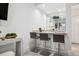 Wet bar with stylish counter stools, granite countertops, and mirrored backsplash at 512 Cook St, Denver, CO 80206