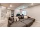 Finished basement boasts recessed lighting, comfortable seating, and stylish decor at 21302 E Radcliff Pl, Aurora, CO 80015