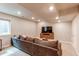 Finished basement features comfortable seating, recessed lights, and a large window at 21302 E Radcliff Pl, Aurora, CO 80015
