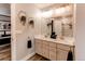 Modern bathroom features dual sinks, gray cabinets, hexagon décor, and stylish fixtures at 21302 E Radcliff Pl, Aurora, CO 80015