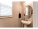 This bathroom features modern fixtures and an oval mirror at 21302 E Radcliff Pl, Aurora, CO 80015
