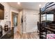 Finished bedroom includes a bunk bed, closet, and easy access to the hallway at 21302 E Radcliff Pl, Aurora, CO 80015