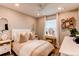 Stylish bedroom features a cozy bed, ceiling fan, vanity, and decor shelves at 21302 E Radcliff Pl, Aurora, CO 80015