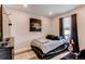 Well-lit bedroom features a platform bed, dark furniture, and stylish decor at 21302 E Radcliff Pl, Aurora, CO 80015