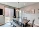 Stylish dining room with gray wood table, bench seating, and sliding door to outdoor living space at 21302 E Radcliff Pl, Aurora, CO 80015