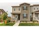 Inviting townhome with landscaped front yard, covered porch, and neutral tones at 21302 E Radcliff Pl, Aurora, CO 80015