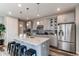 Modern kitchen with stainless steel appliances, center island, and stylish pendant lighting at 21302 E Radcliff Pl, Aurora, CO 80015