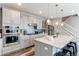 Updated kitchen featuring modern gray cabinets, sleek appliances, and a beautiful backsplash at 21302 E Radcliff Pl, Aurora, CO 80015
