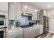 Contemporary kitchen with stainless appliances, stylish backsplash, and ample counter space at 21302 E Radcliff Pl, Aurora, CO 80015