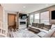 Comfortable living room with fireplace, built-in shelving, and ample natural light at 21302 E Radcliff Pl, Aurora, CO 80015