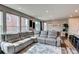 Spacious living room with large windows, modern decor, and wood-look floors at 21302 E Radcliff Pl, Aurora, CO 80015