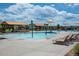 Resort-style pool with splash pad, lounge chairs, covered seating, and clear blue skies at 21302 E Radcliff Pl, Aurora, CO 80015