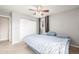 Cozy bedroom featuring a ceiling fan, closet, and comfortable blue bedding at 10723 Sperry St, Northglenn, CO 80234