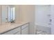 Bright bathroom featuring white vanity with stone countertop and tiled shower-tub combination at 728 N Bently St, Watkins, CO 80137
