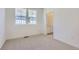 Bright bedroom with a window, neutral carpet, and an ensuite bathroom entrance at 728 N Bently St, Watkins, CO 80137