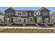 Beautiful townhome exterior featuring stone accents, varied siding, and a well-maintained front yard at 728 N Bently St, Watkins, CO 80137