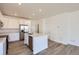 Contemporary kitchen featuring stainless steel appliances, white cabinetry, and a kitchen island at 728 N Bently St, Watkins, CO 80137