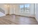 Bright living room with hardwood floors, large windows, and plenty of natural light at 728 N Bently St, Watkins, CO 80137