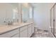 Elegant main bathroom featuring double sinks, marble floors, and a glass shower at 728 N Bently St, Watkins, CO 80137