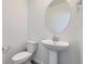 Clean powder room featuring a pedestal sink and modern fixtures at 728 N Bently St, Watkins, CO 80137